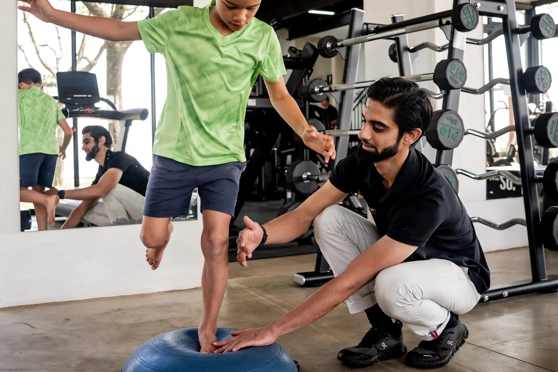 A Movewell biokineticist guiding a child through a balance exercise